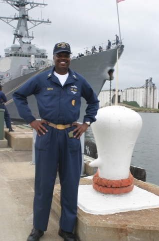 CMDCM(SW/AW) Anthony T. Smith standing in front of the ADMIRAL DESTROYER  USS ARLEIGH BURKEs CMC from  JUN 2007- MAY 2010. Class of 82